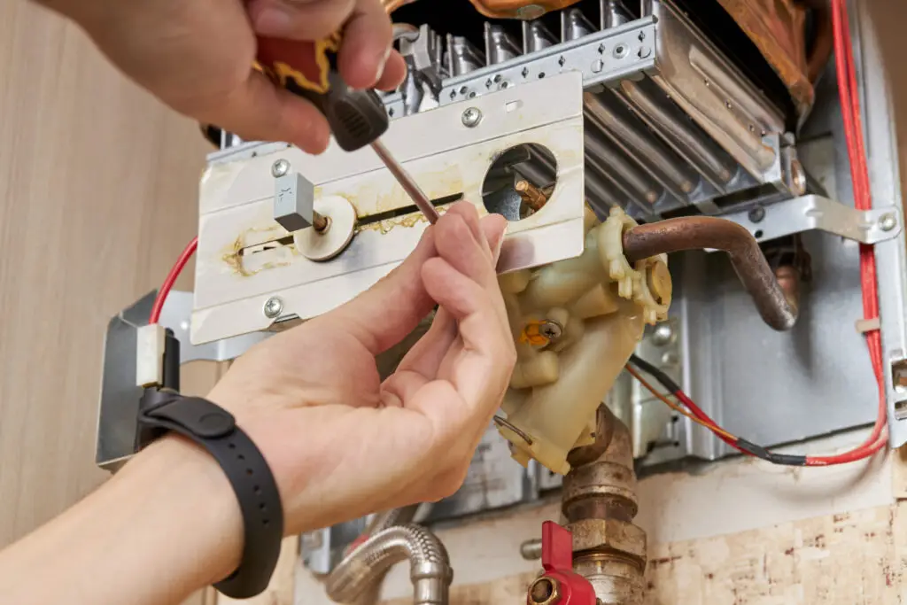 November Special Offer - Boiler Service only £60+vat 1 Gas engineer repairing a boiler - servicing